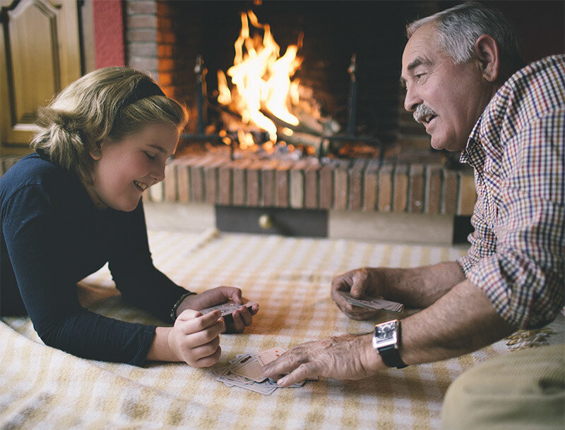 Happy Grandpa in front of fireplace