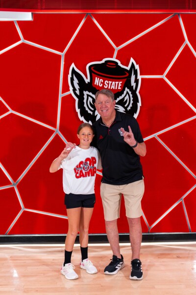 Kate Bowman is pictured with the NC State Women’s Basketball Coach, Wes Moore. 